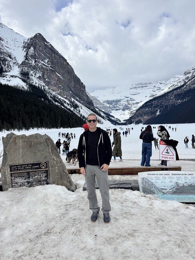 Lake Louise in Banff, still water beneath the mountains